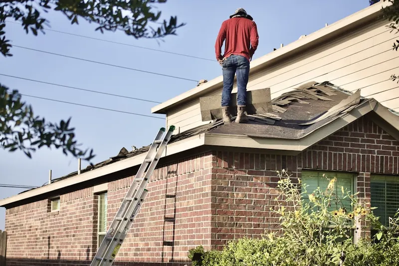 Professional roofer working on a residential roof in Rivershire